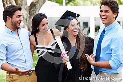 Hispanic Student And Family Celebrating Graduation Stock Photo