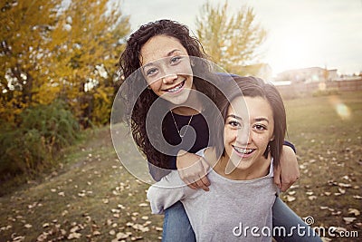 Hispanic Teenage girls having fun together outdoors Stock Photo