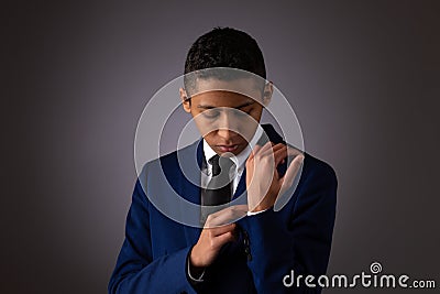 Hispanic Teenager Boy Well Dressed Fixing His Shirt Cuff Stock Photo