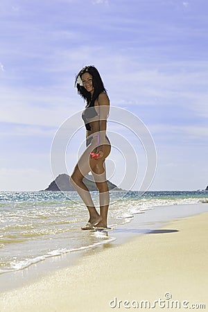 Hispanic woman in bikini at the beach Stock Photo