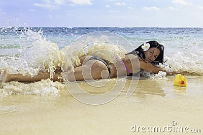 Hispanic woman in bikini at the beach Stock Photo