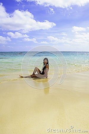 Hispanic woman in bikini at the beach Stock Photo