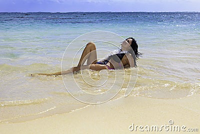 Hispanic woman in bikini at the beach Stock Photo