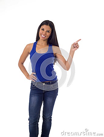 Hispanic woman in casual top and jeans smiling happy and cheerful pointing with finger presenting Stock Photo