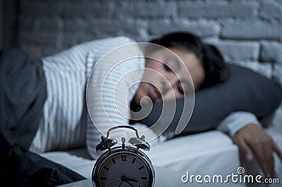 Hispanic woman at home bedroom lying in bed late at night trying to sleep suffering insomnia Stock Photo