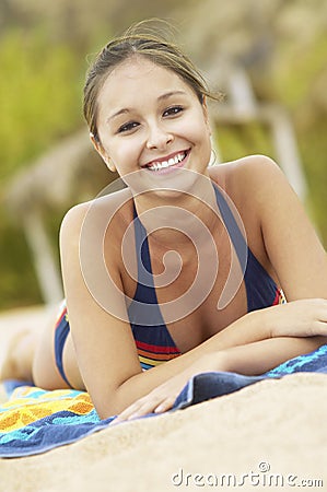 Hispanic Woman Relaxing At Beach Stock Photo