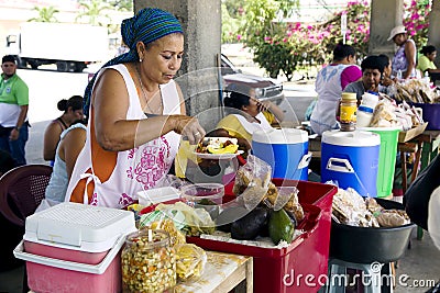 Hispanic woman sells the prepared meal Editorial Stock Photo
