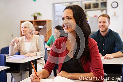 Hispanic woman studying at adult education class looking up Stock Photo