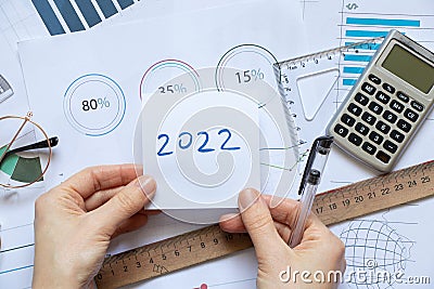 Histograms on paper on the table in the hands of a girl, analytics and statistics on paper, business intelligence, a plan for the Stock Photo