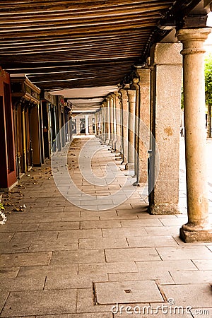 Historic arcade in the center of HalcalÃ¡ with stone columns and wooden ceiling Stock Photo