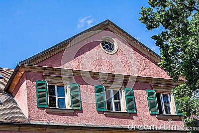 Historic building with lattice windows and green shutters Editorial Stock Photo