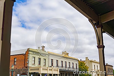 Historic buildings framed by veranda across road Editorial Stock Photo