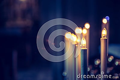 Awestruck catholic church in Italy with electric candles Stock Photo