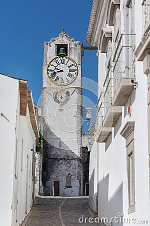 Historic clock tower view - Church of Santa Maria do Castelo- in the city Tavira, Algarve, Portugal Stock Photo