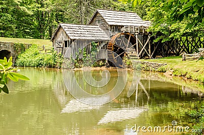 Historic Edwin B. Mabry Grist Mill (Mabry Mill) in rural Virginia on Blue Ridge Parkway and reflection on pond in summer Stock Photo