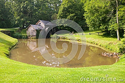 Historic Edwin B. Mabry Grist Mill (Mabry Mill) in rural Virginia on Blue Ridge Parkway and reflection on pond in summer Stock Photo