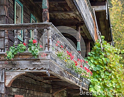 Historic farmhouse front with red geraniums. Stock Photo