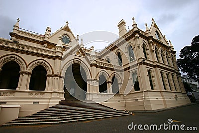 Beige gothic revival Parliamentary Library with classic colonnade porch entry on grand stairs, Wellington, New Zealand Stock Photo