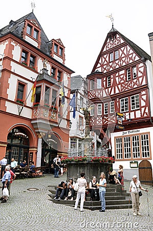 Historic half-timbered houses, tourists in Bernkastel Editorial Stock Photo