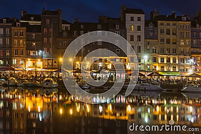 Historic harbor Honfleur with sailing ships in the evening, France Editorial Stock Photo