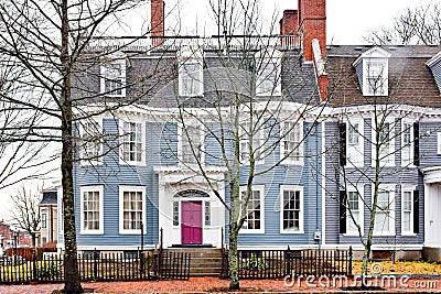 Historic House with Purple Door and Wrought Iron Fence Editorial Stock Photo