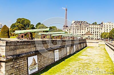 Historic Napoleonic artillery gun near National Residence of Invalids with the Eiffel tower in the background Editorial Stock Photo