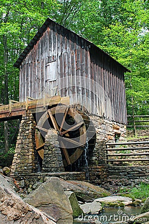 A historic mill in a forest with green leafs in late spring. Stock Photo