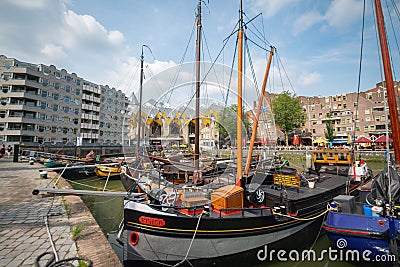 Historic sailing vessels moored along pier in city`s Old Harbour area with apartment buildings in background Editorial Stock Photo