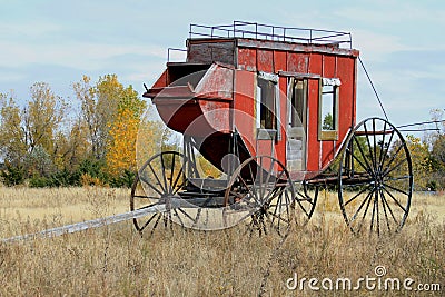Historic Stage Coach sits in a field Stock Photo