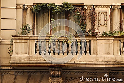 Historic stone balcony with lush vegetation in Barcelona, Spain Editorial Stock Photo