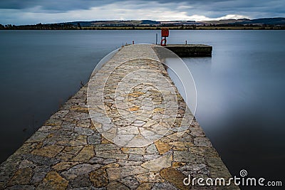 Historic stone jetty on Loch Leven, Scotland. Stock Photo