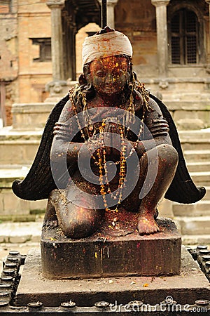 A historic stone statue of a praying female in Patan, a suburb of Kathmandu, Nepal Stock Photo