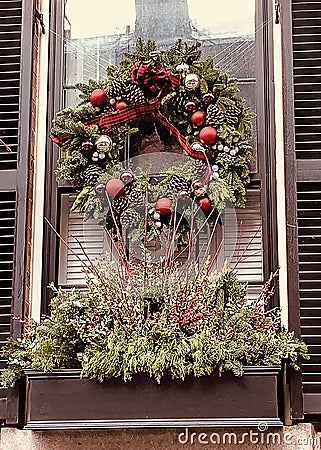 Close-up of window on home in historic town with large pine-cone wreath Stock Photo