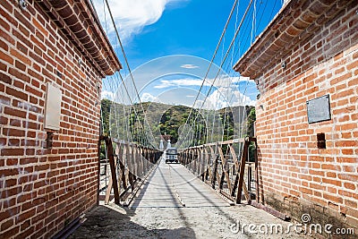 The historical Bridge of the West a a suspension bridge declared Colombian National Monument built in 1887 over the Cauca River Stock Photo