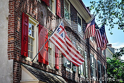 Historical Flags on a Old City building in Elfreth`s Alley Stock Photo