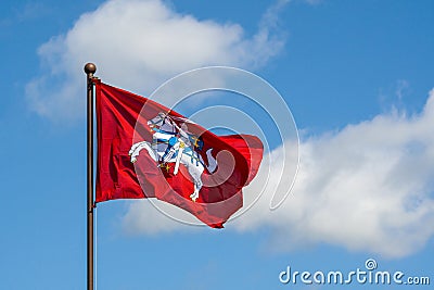 Historical Lithuanian flag waving in the wind against blue sky Stock Photo