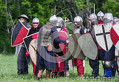 Historical reenactors in suits and with weapons in the ranks Editorial Stock Photo