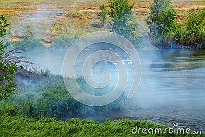 Historical reenactors in the uniform of the Red Army soldiers during the Second World War cross the river Editorial Stock Photo