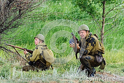 Historical reenactors in the uniforms of the Red Army during the Second World War are fighting in the offensive Editorial Stock Photo