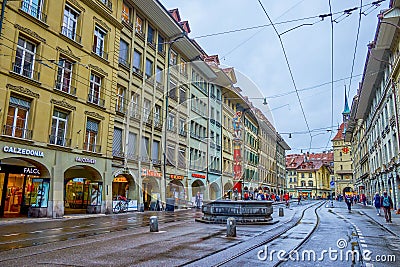 Historical Spitalgasse street in Innere Neustadt with colorful Pfeiferbrunnen fountain in the middle of the road in Bern, Editorial Stock Photo
