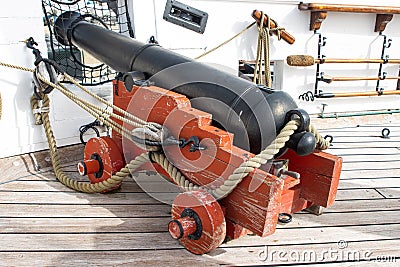 Historirical old metal cannon on battle sailing vessel Stock Photo