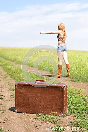 Hitchhiker with a suitcase Stock Photo