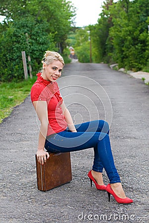 Hitchhiker with suitcase Stock Photo