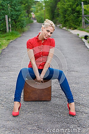 Hitchhiker with suitcase Stock Photo