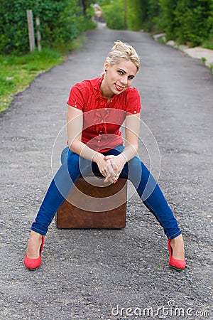 Hitchhiker with suitcase Stock Photo