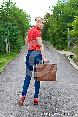 Hitchhiker with suitcase Stock Photo