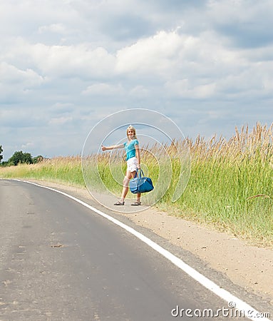 Hitchhiking girl votes on road Stock Photo
