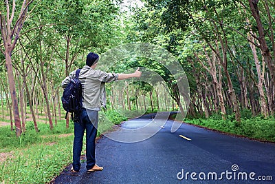 Hitchhiking tourism concept. Travel hitchhiker man carrying back Stock Photo
