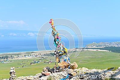 Hitching post with ribbons of shamanism religion in Khuzhir, island Olkhon. Stock Photo