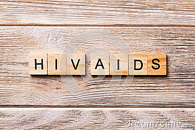 HIV AIDS word written on wood block. HIV AIDS text on wooden table for your desing, concept Stock Photo